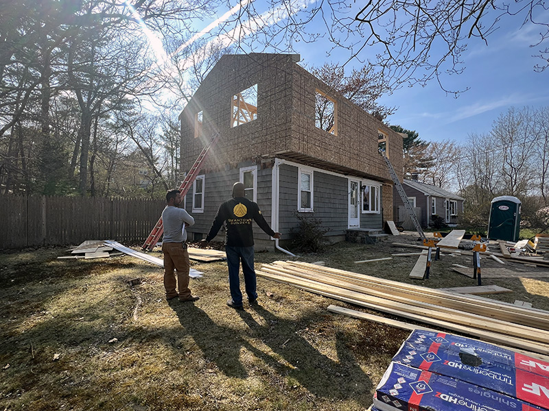 two men looking at second story addition